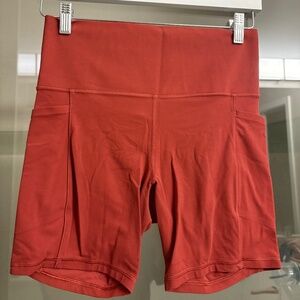 Athleta Rust Red Salutation Stash Pocket ll 7” Bike Short | Size M